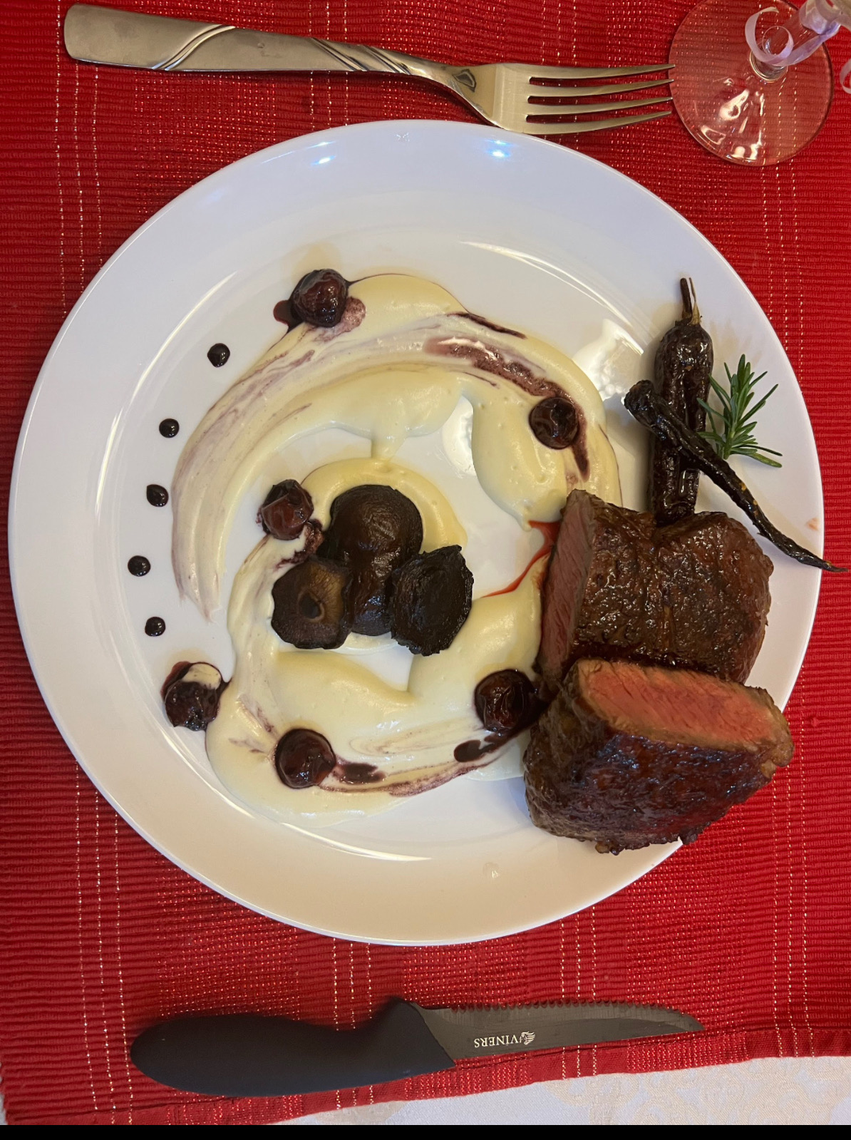 Ribeye with celeriac puree, cherry sauce, mushrooms, and hot honey carrots