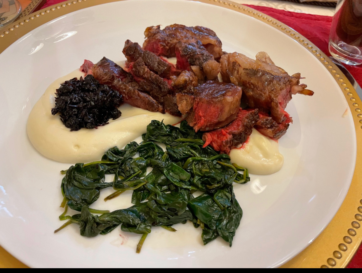 Ribeye round with whipped potatoes, shallot red wine jam, and buttered spinach